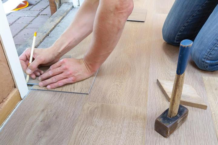 Person measuring on a wood floor